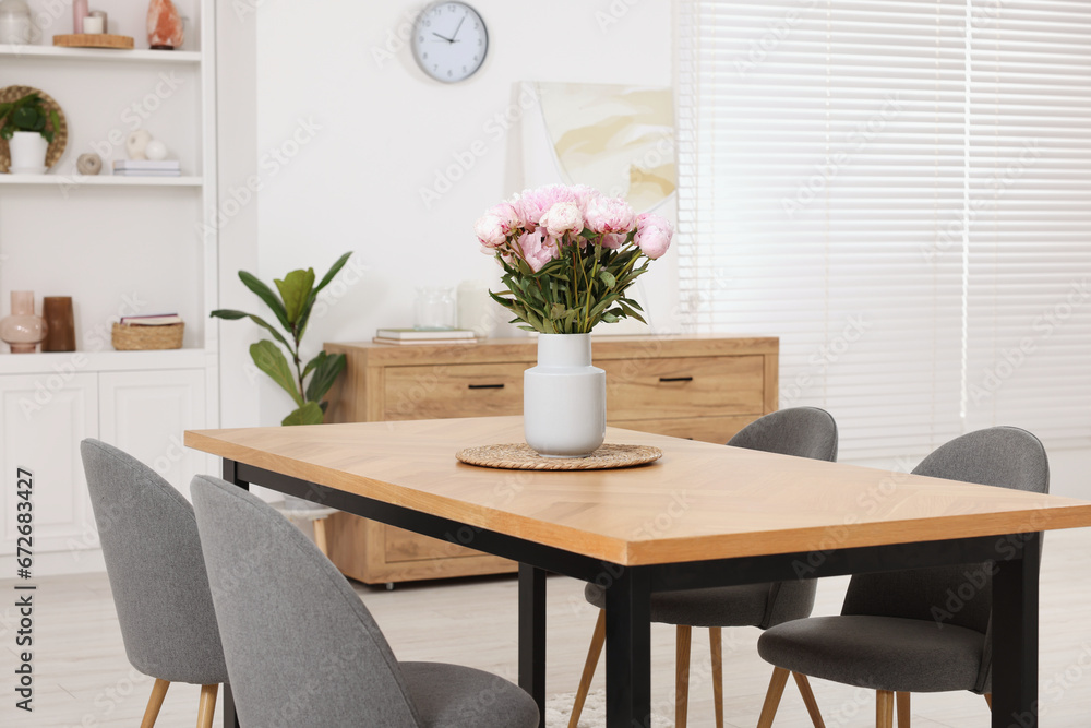 Stylish dining room with cosy furniture and flowers Stylish dining room with cosy furniture and flowers