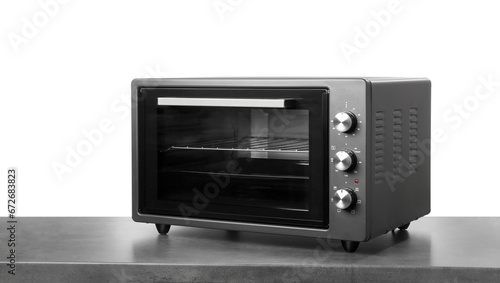 One electric oven on grey table against white background