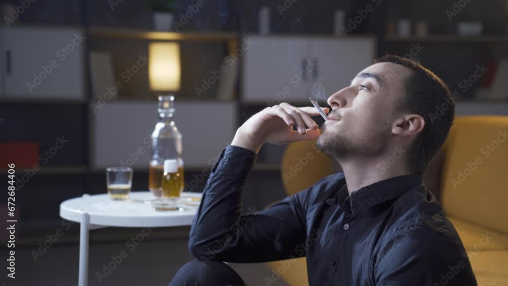Unhappy young man smokes a cigarette. Unhappy young man smokes a cigarette.