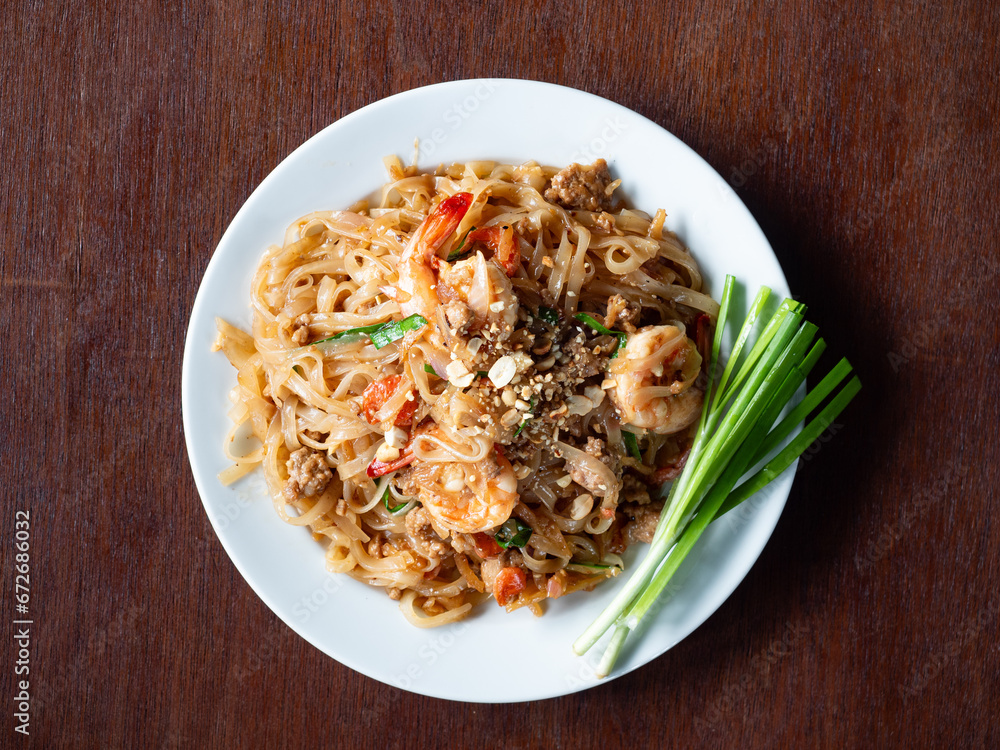 top view dish of Pad Thai with shrimp on wood