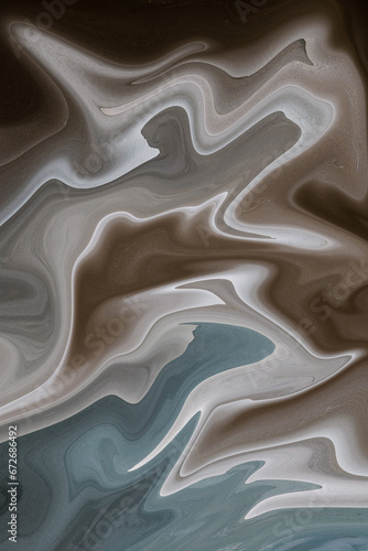 A close-up of a fluid-like texture in shades of gray and blue, giving a smooth and glossy appearance, abstract background