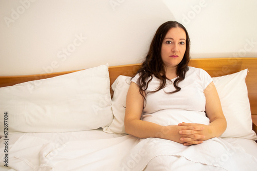Shot of a woman lying in bed and ignoring and abandoned. Woman alone in her bed with copy space.