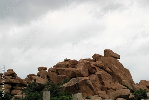 Hampi, Karnataka India - July 24 2023: Kishkinda, Anjanadri Hill, Anjaneya Parvat, the birthplace of Hanuman God now a white temple on top of beige boulder hill. photo