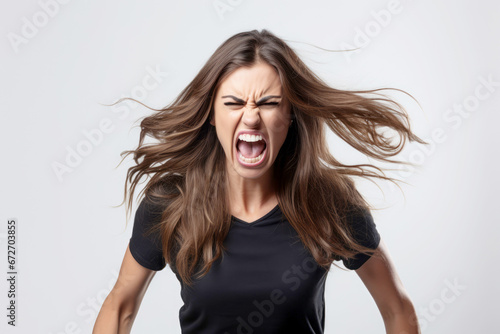 A woman screaming in an aggressive and furious portrait, expressing her displeasure.