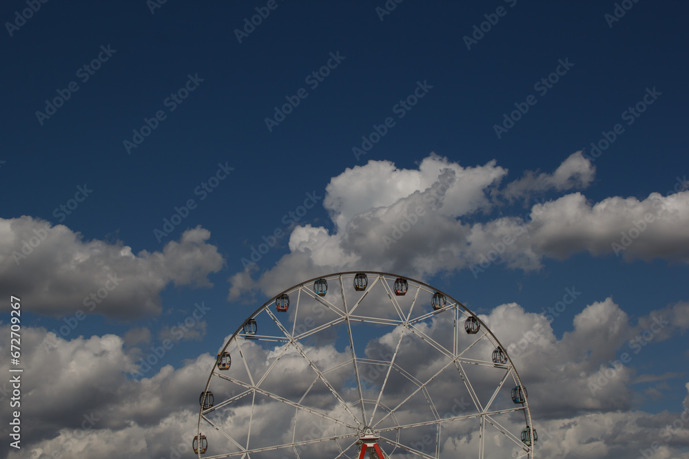 Attraction Ferris wheel against the sky with clouds. selective focus. High quality photo