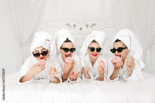 Bild auf Leinwand Young, beautiful women in bathrobes and glasses enjoying bachelorette party at s
