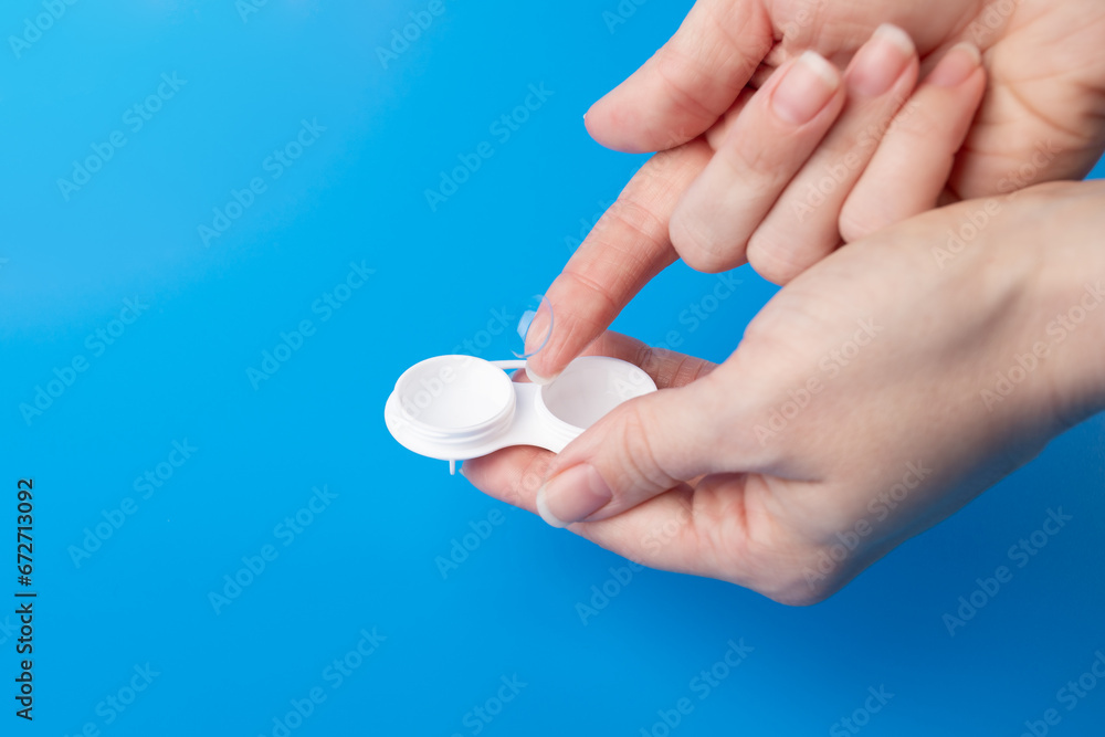 Optical care, transparent lens for astigmatism and eye health in hand with a lenses case Optical care, transparent lens for astigmatism and eye health in hand with a lenses case
