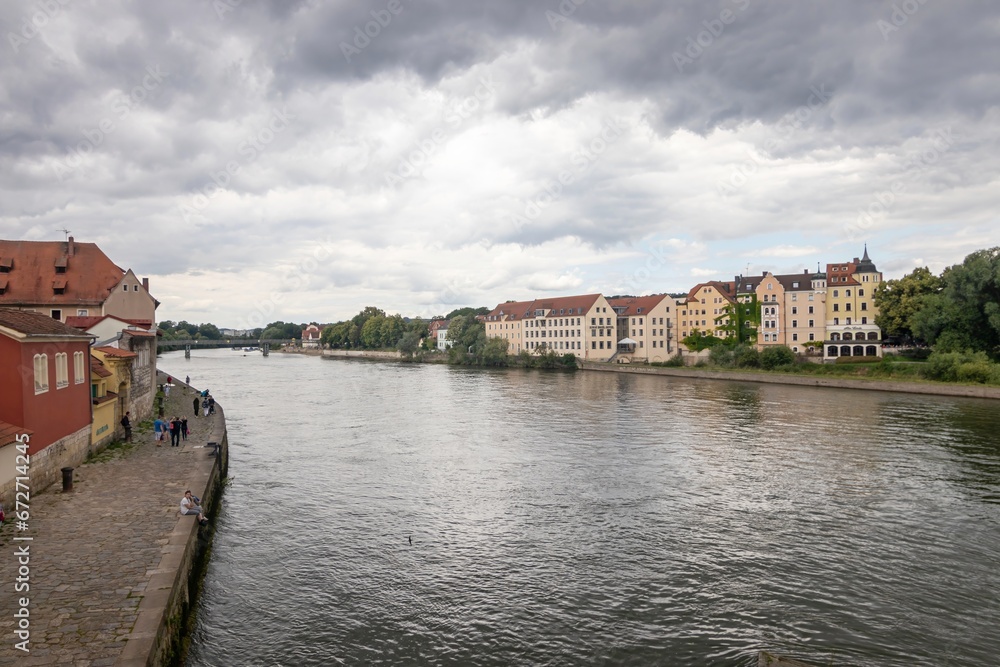 Fototapeta premium Danube River and residential building on Oberer Wöhrd island as viewed from the Old Stone Bridge (German: Steinerne Brücke), Regensburg