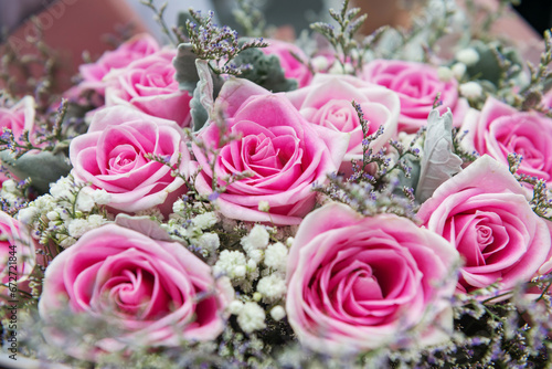 Pink roses bouquet with white grass flowers