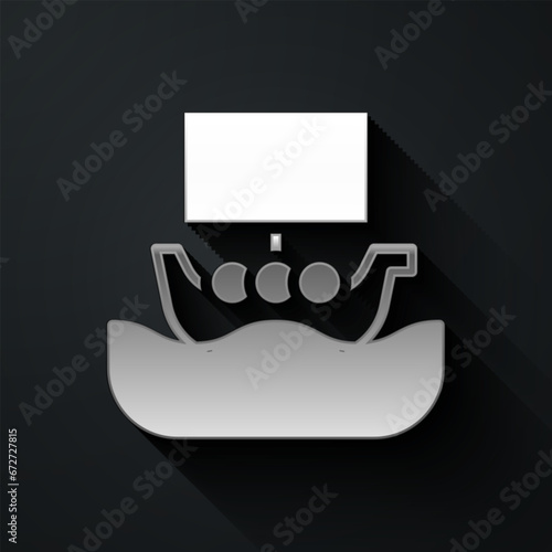Silver Ancient viking scandinavian drakkar icon isolated on black background. Viking transport ship. Long shadow style. Vector