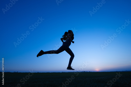 Wallpaper Mural silhouette of a young woman running against a background of blue sky during sunset Torontodigital.ca