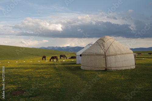 Nomadic life in Kyrgyzstan, herd of horses, yurts, meadows and kyrgyzs native people