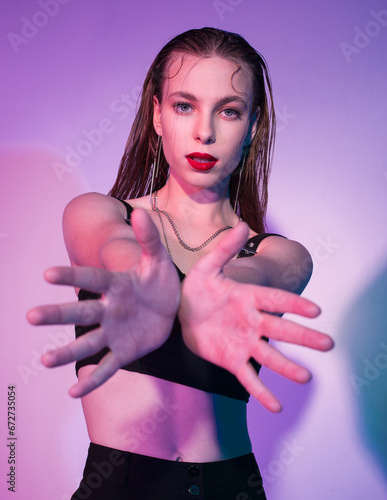 confident girl stretches out her arms in a dance photo