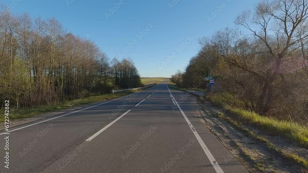 The car drives along the road on a autumn day. Highways, roadside and road line markings. The car drives along the road on a autumn day. Highways, roadside and road line markings.