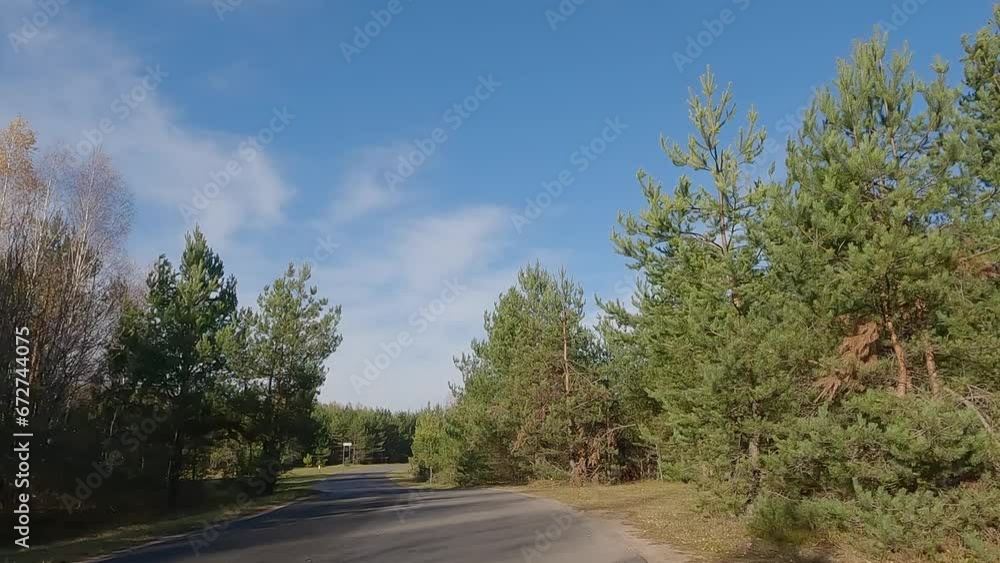 The car drives along the road on a autumn day. Highways, roadside and road line markings. The car drives along the road on a autumn day. Highways, roadside and road line markings.