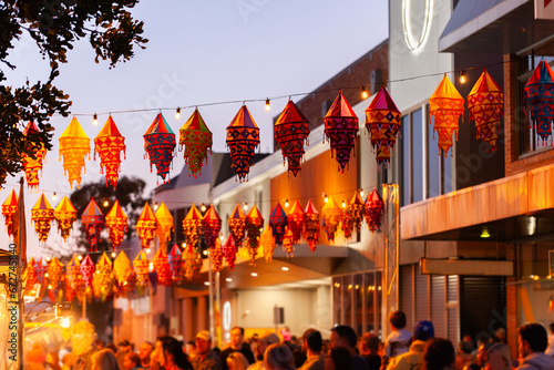 Multicultural celebration event with lanterns hanging above crowd photo