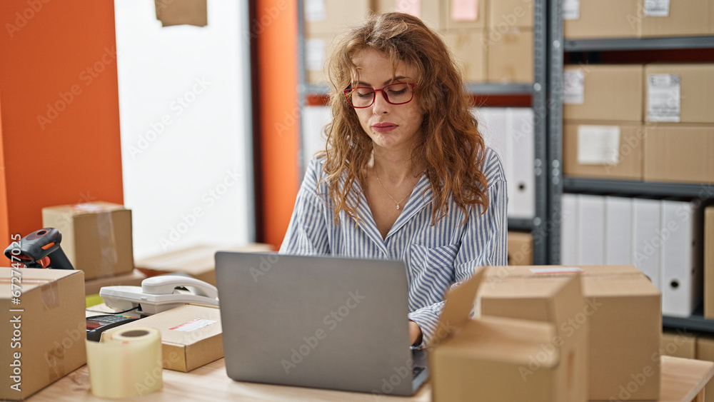 Young woman ecommerce business worker using laptop at office Young woman ecommerce business worker using laptop at office