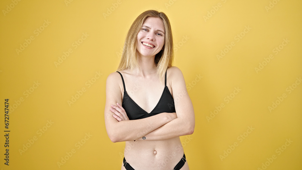 Φωτογραφία Young blonde woman tourist wearing bikini standing with arms crossed gesture ove