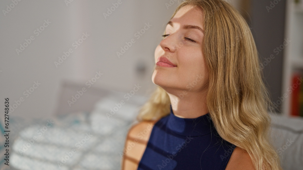 Young blonde woman relaxing on sofa breathing at home Young blonde woman relaxing on sofa breathing at home