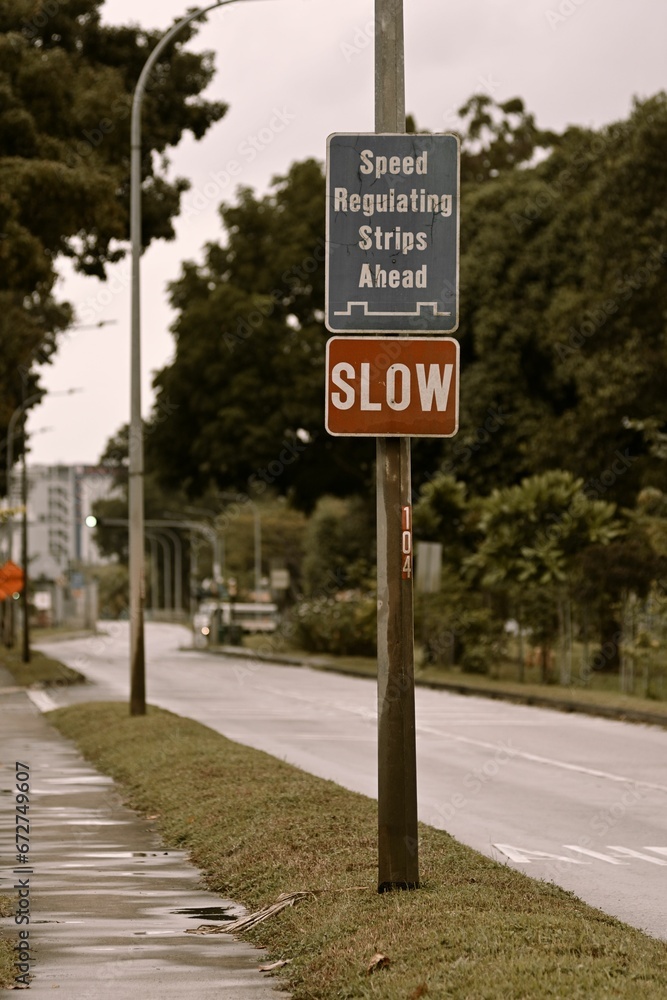 Vertical shot of a speed regulating strips ahead warning sign on a road Vertical shot of a speed regulating strips ahead warning sign on a road