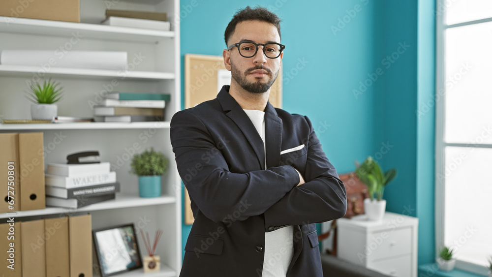 Young arab man business worker standing with arms crossed gesture and serious face at the office Young arab man business worker standing with arms crossed gesture and serious face at the office