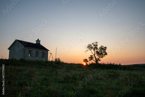 Sunrise in the Kansas Flint Hills with an old 1880's school in the foreground.