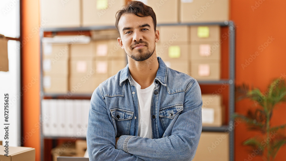 Young hispanic man ecommerce business worker standing with arms crossed gesture at office Young hispanic man ecommerce business worker standing with arms crossed gesture at office