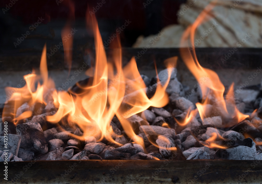 A charcoal stove lit to make Adana kebap A charcoal stove lit to make Adana kebap