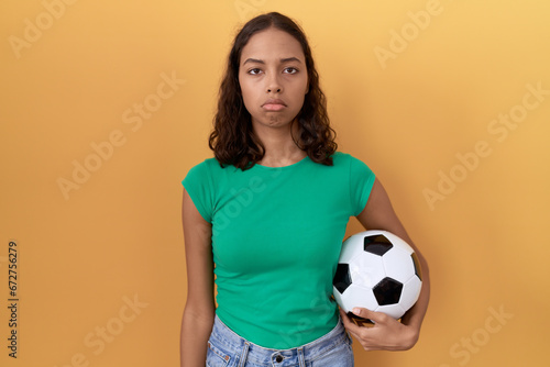 Young hispanic woman holding ball depressed and worry for distress, crying angry and afraid. sad expression. © Krakenimages.com