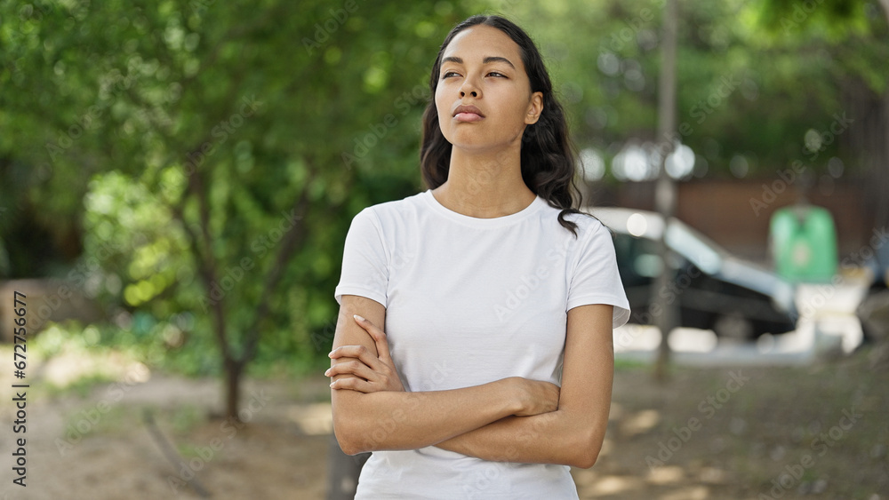 African american woman standing with arms crossed gesture at park African american woman standing with arms crossed gesture at park