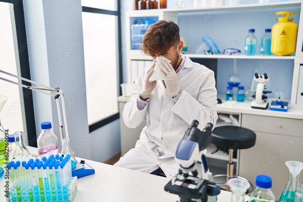Young arab man scientist using napkin at laboratory Young arab man scientist using napkin at laboratory