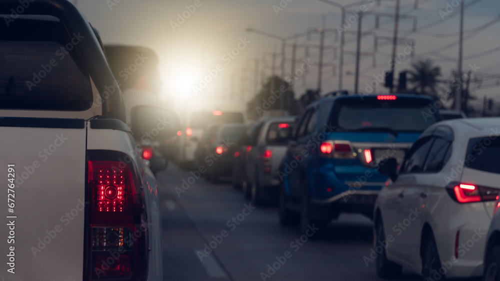 Rear side of pickup car white color with turn on brake light on asphalt roads. During rush hours for travel or business work. Environment of traffic jam with many cars.
