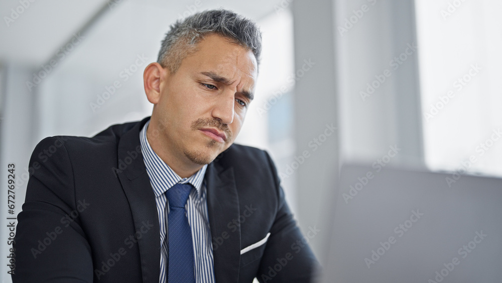 Young hispanic man business worker using laptop at office Young hispanic man business worker using laptop at office