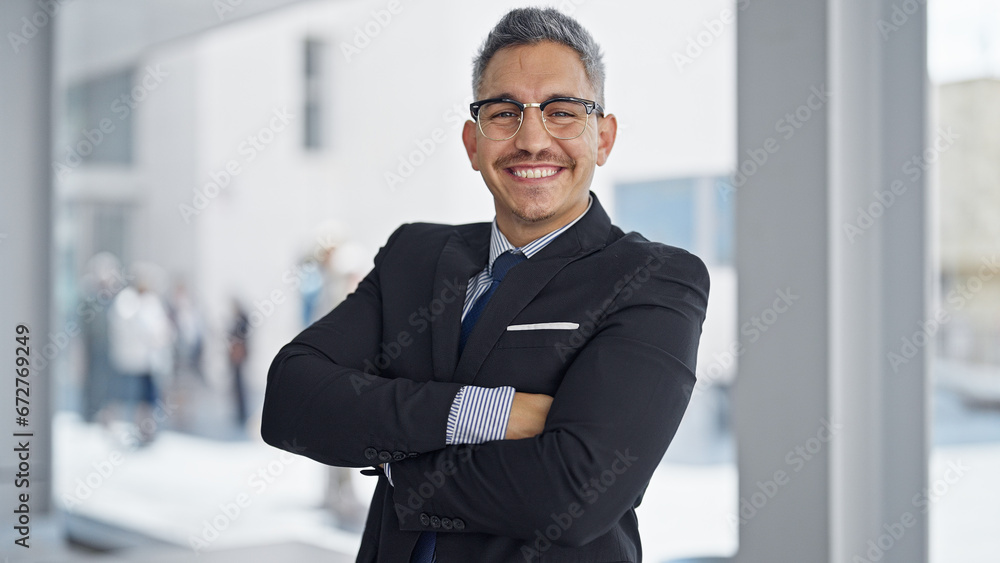Young hispanic man business worker smiling confident standing with arms crossed gesture at office Young hispanic man business worker smiling confident standing with arms crossed gesture at office