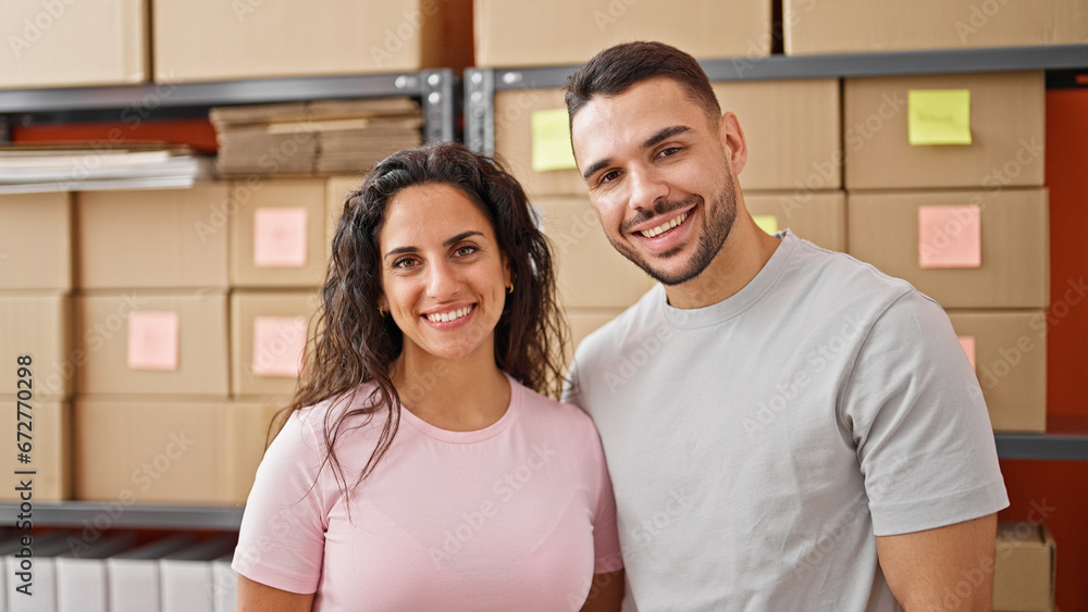 Man and woman ecommerce business workers standing together smiling at office Man and woman ecommerce business workers standing together smiling at office