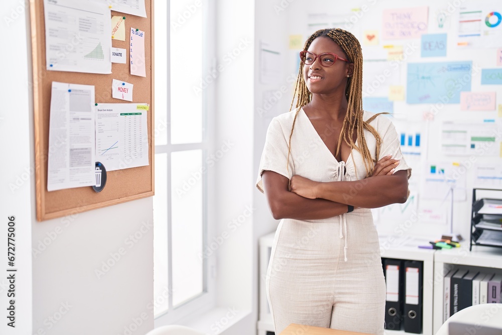 African american woman business worker smiling confident standing with arms crossed gesture at office African american woman business worker smiling confident standing with arms crossed gesture at office