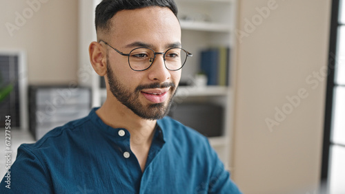 Young hispanic man business worker working at the office