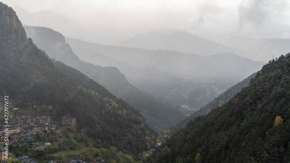 
clouds over the mountains of the Pyrenees, which form a V between themselves.