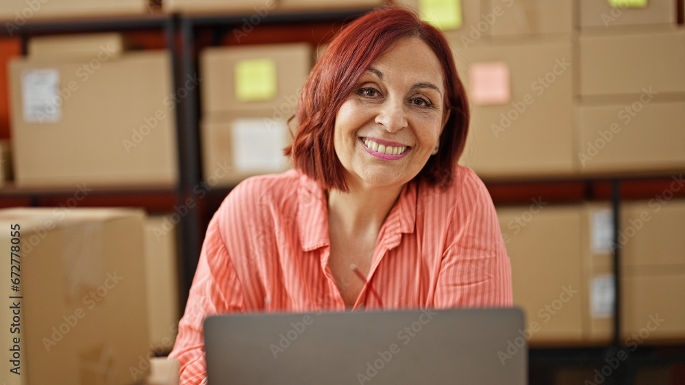 Middle age woman ecommerce business smiling at office Middle age woman ecommerce business smiling at office