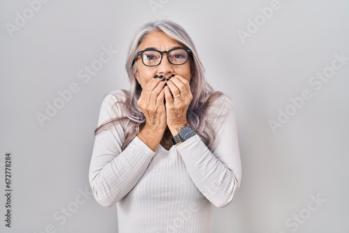Canvastavla Middle age woman with grey hair standing over white background laughing and emba