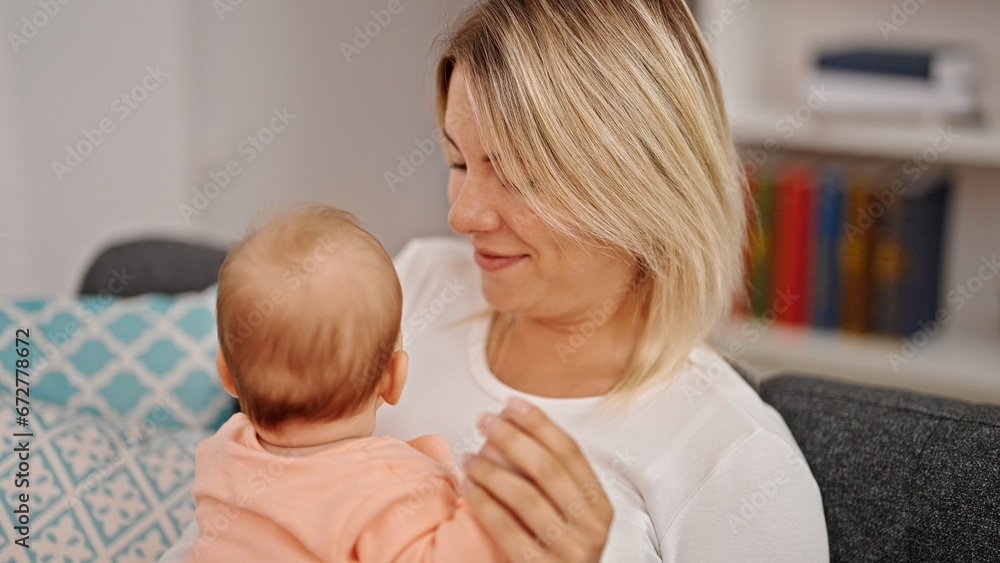 Mother and daughter hugging each other at home Mother and daughter hugging each other at home