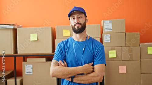 Young hispanic man ecommerce worker standing with arms crossed gesture at office © Krakenimages.com