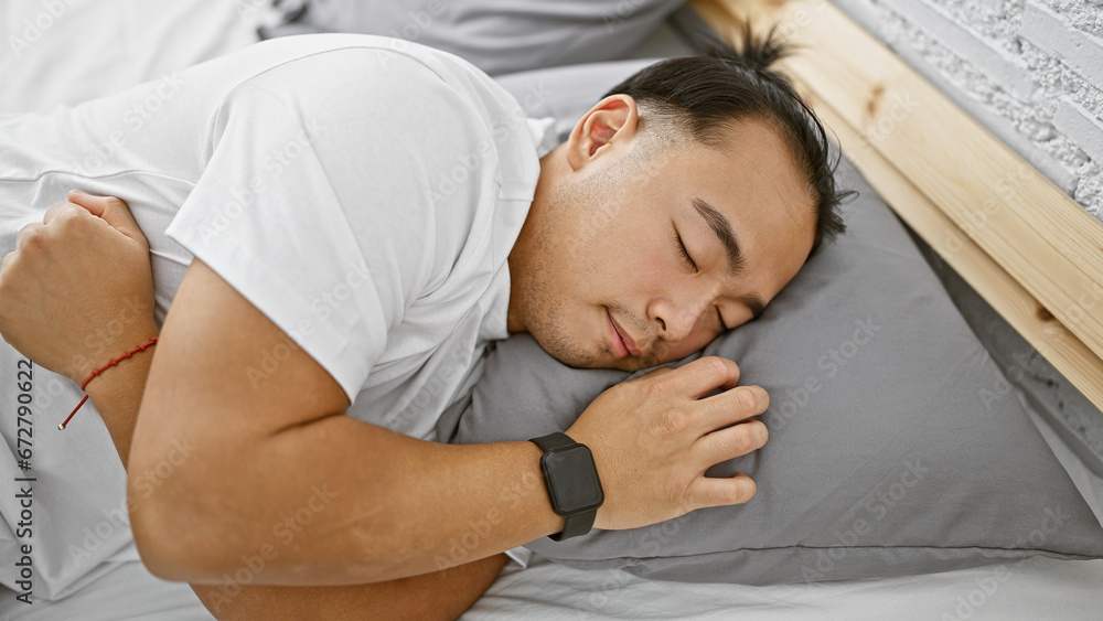 Φωτογραφία Handsome young chinese man in pajamas, comfortably asleep, tired yet relaxed, lying in the cozy sanctuary of his bedroom, home, a personification of relaxation indoors in the morning