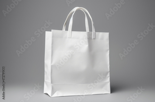 An empty white paper shopping bag sits on a clean white surface, surrounded by white studio lighting. It's perfect for product ad branding and CI retouching. Generative AI.