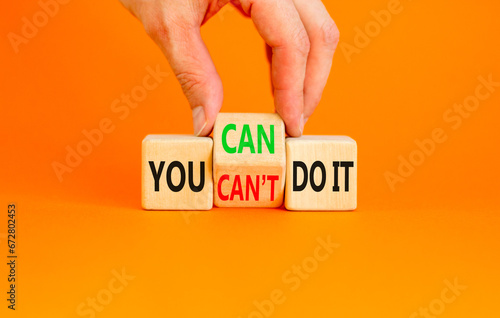 You can do it symbol. Concept word You can or can not do it on beautiful wooden cubes. Beautiful orange table orange background. Businessman hand. Business and you can or not do it concept. Copy space