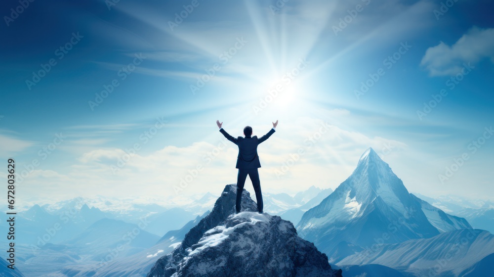 Silhouette of a businessman standing on top of a mountain, Business and success concept