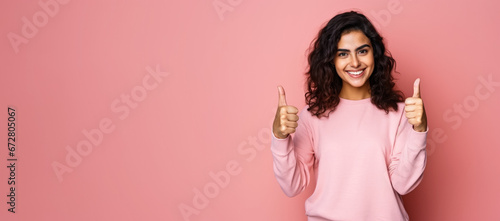 Happy smiling young woman, showing approving thumbs up, studio portrait pink background - wide banner copy space on side. Generative AI photo