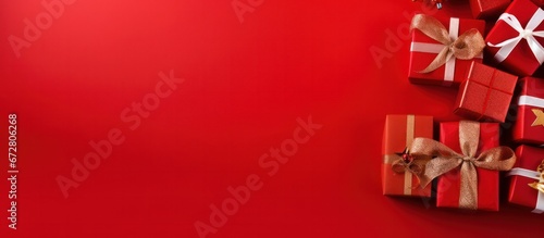 Banner with many gift boxes tied velvet ribbons and paper decorations on red background. Christmas background, copy space
