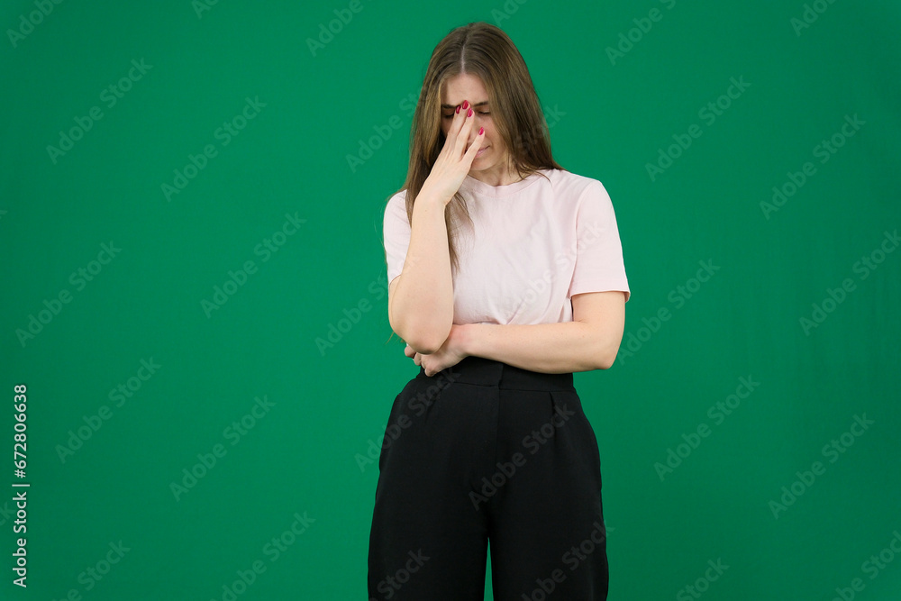 different emotions of a young girl on a green background chromakey beautiful facial features real people pink T-shirt white skinned European. black flared wide leg trousers different emotions of a young girl on a green background chromakey beautiful facial features real people pink T-shirt white skinned European. black flared wide leg trousers