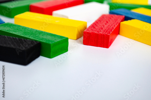 Colorful wooden blocks on white background with customizable space for text. Copy space.
